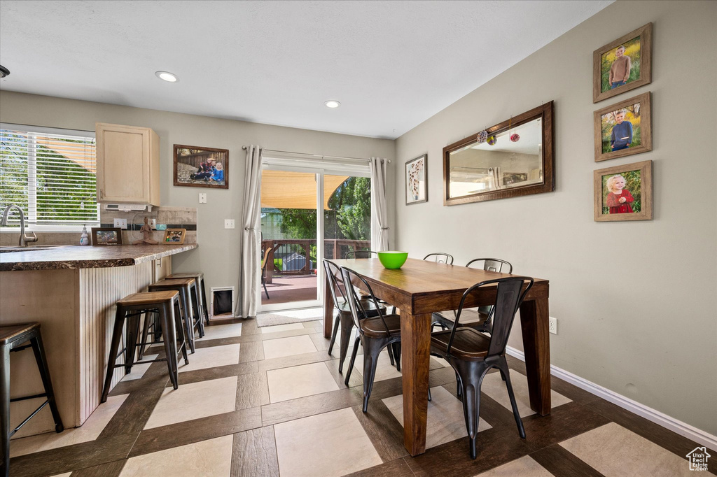 Dining room featuring recessed lighting, inlaid floor details, and baseboards