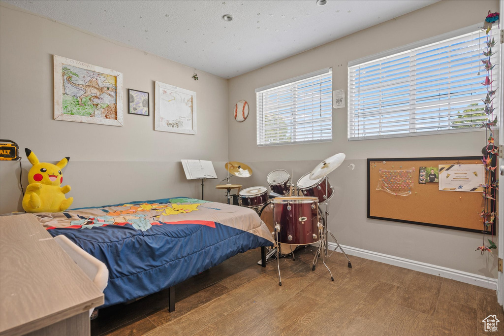 Bedroom featuring wood finished floors and baseboards