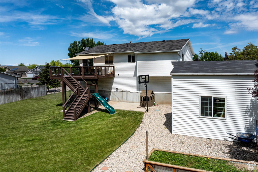 Back of house featuring a wooden deck and stairway