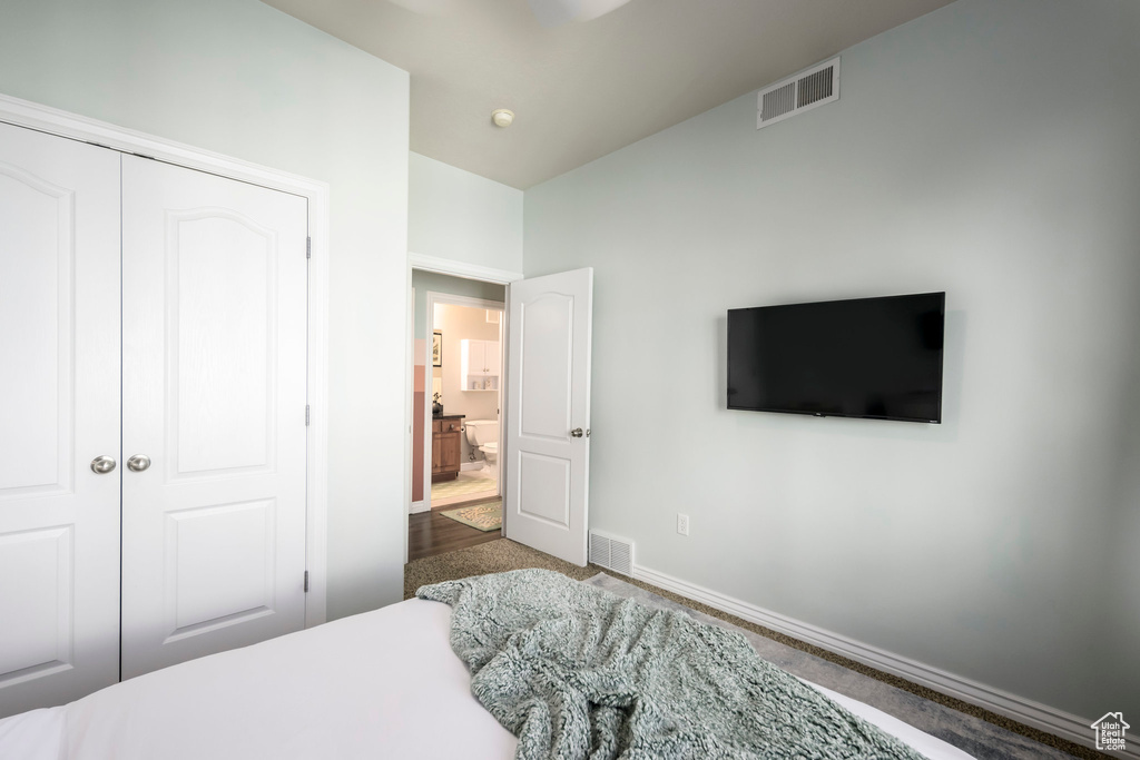 Bedroom featuring baseboards, carpet flooring, and a closet