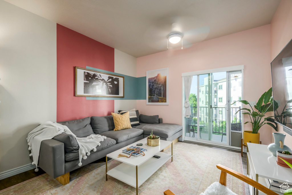 Living area with wood finished floors and ceiling fan