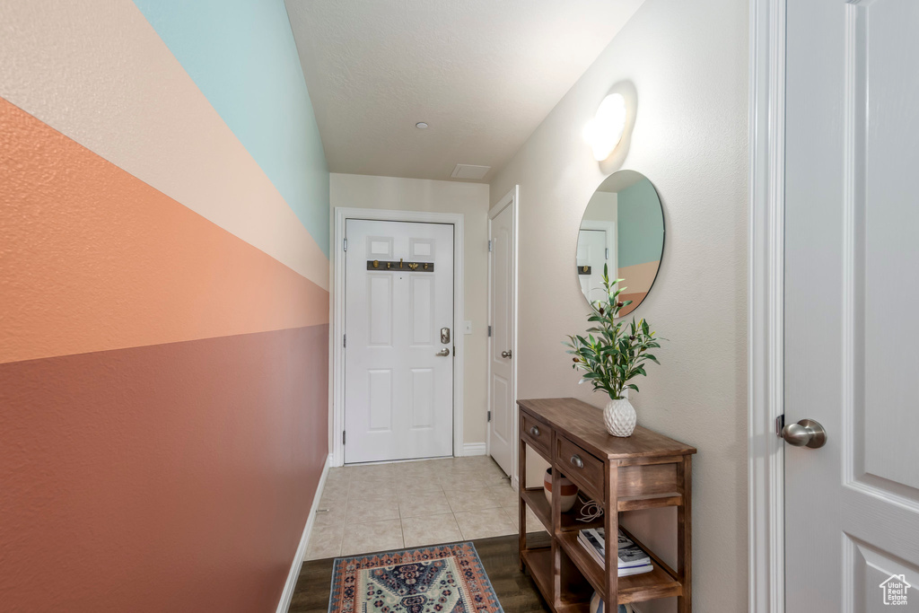 Entryway featuring tile patterned flooring and baseboards