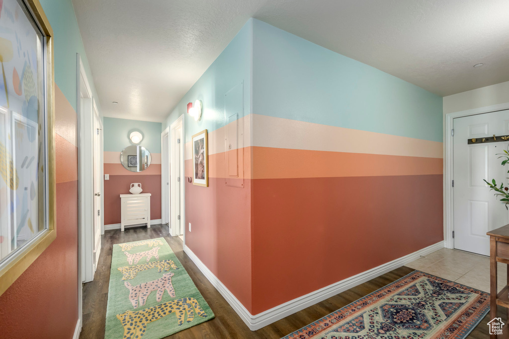 Hall featuring wood finished floors and baseboards