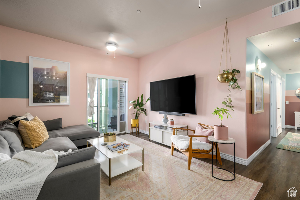 Living room featuring wood finished floors, ceiling fan, and baseboards
