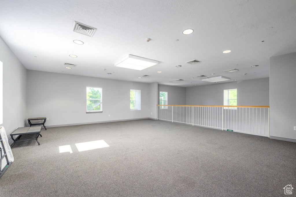 Spare room featuring recessed lighting and carpet floors