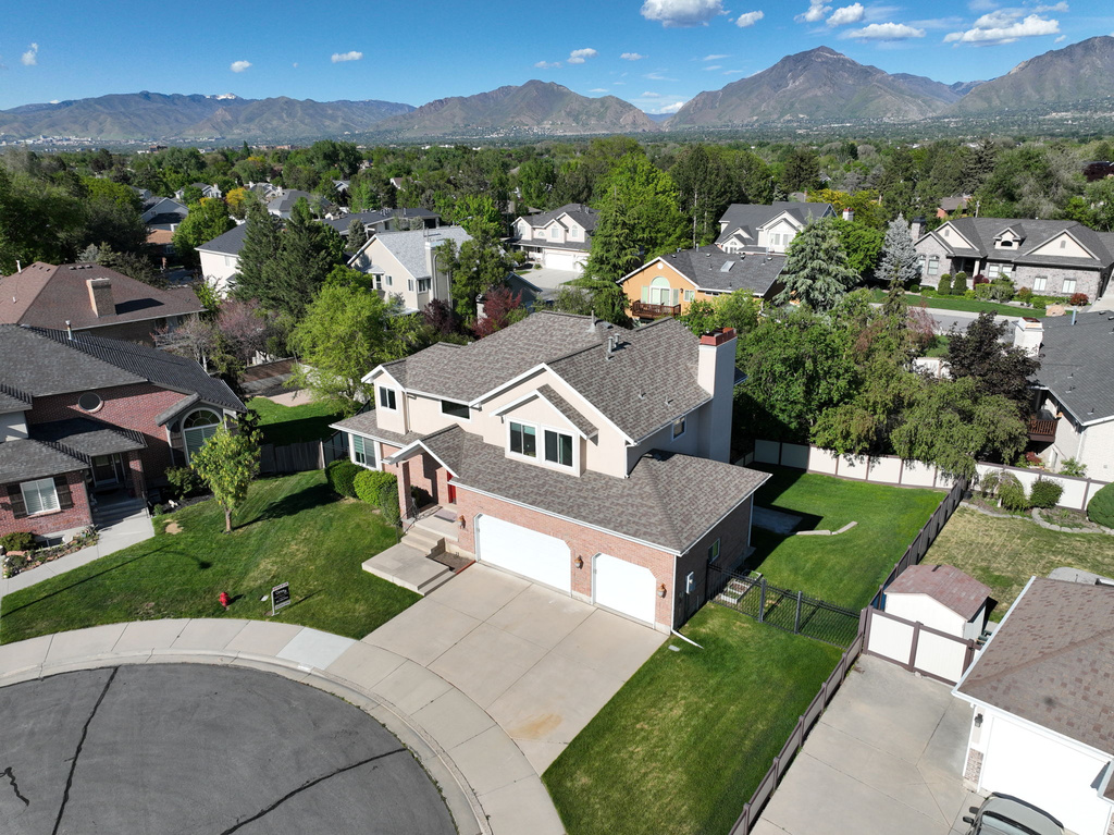 Aerial perspective of suburban area featuring a mountainous background