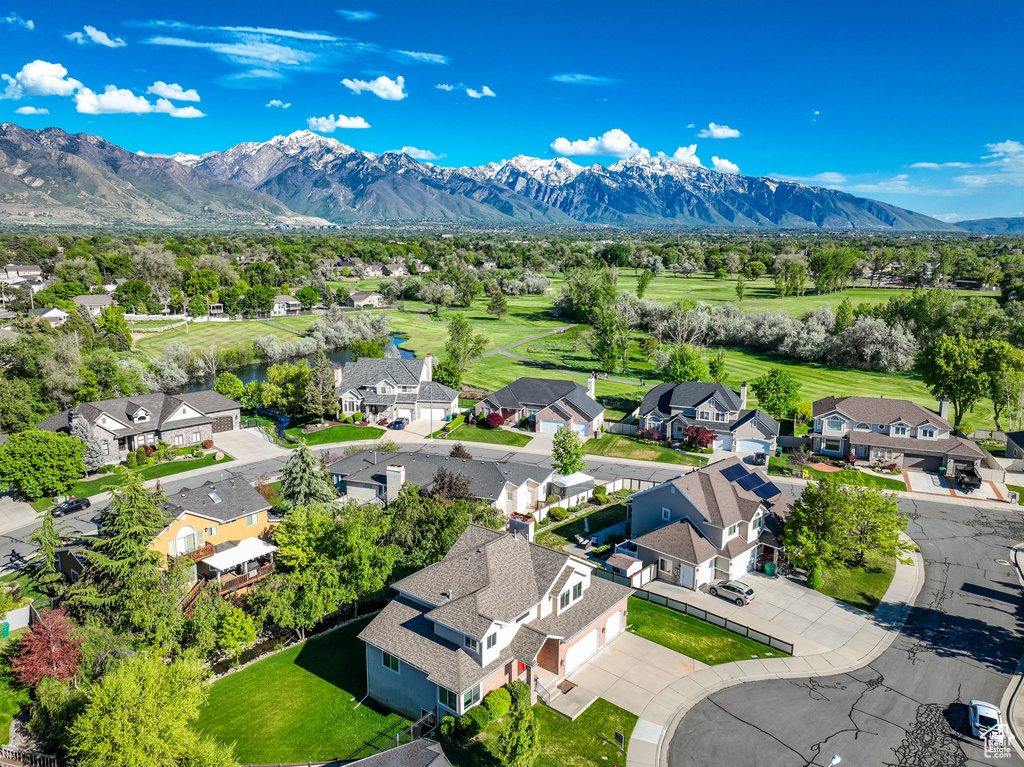 Aerial perspective of suburban area with a mountain backdrop