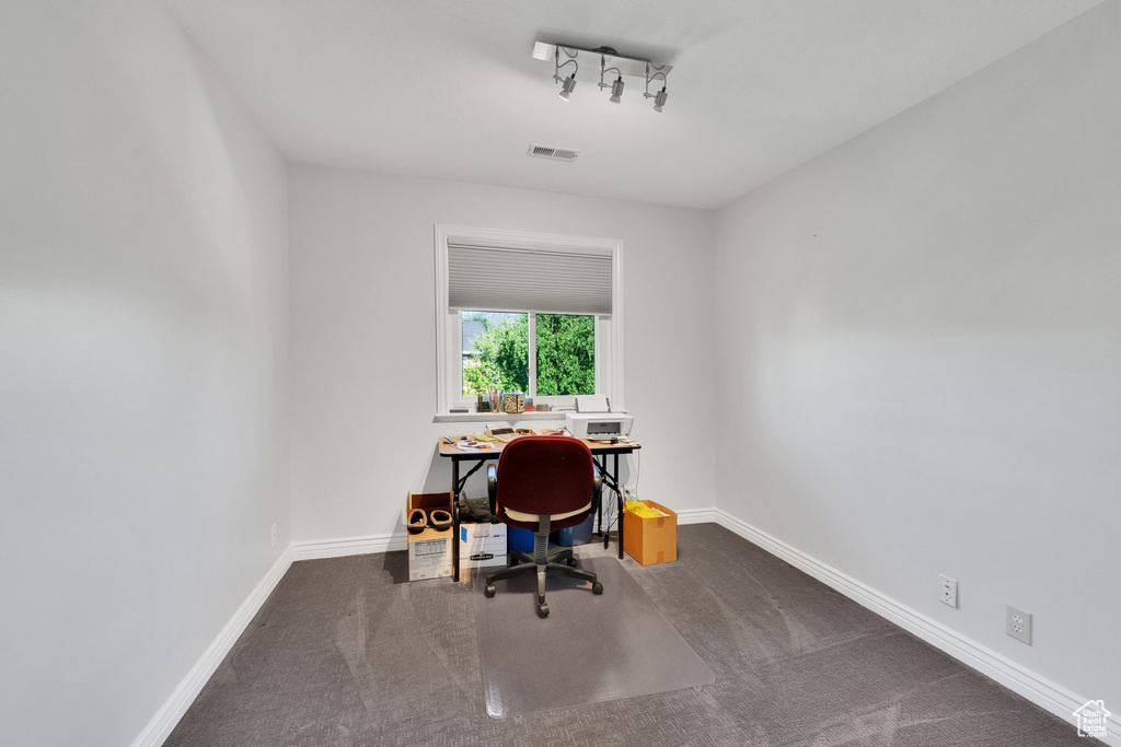 Carpeted office with baseboards