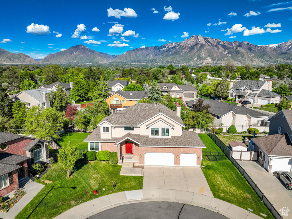 Aerial view of residential area featuring a mountain backdrop