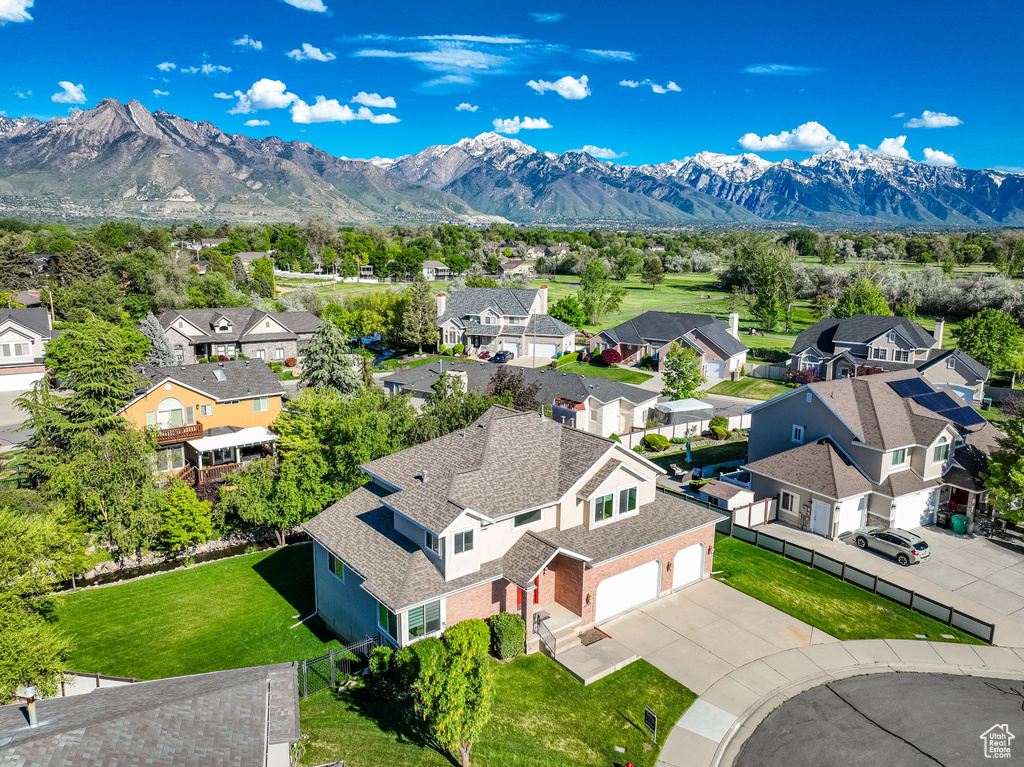 Aerial view of residential area featuring a mountainous background
