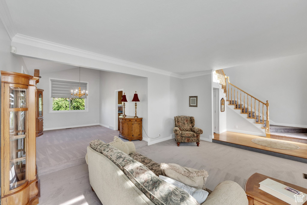 Living area with carpet floors, a chandelier, crown molding, stairway, and baseboards