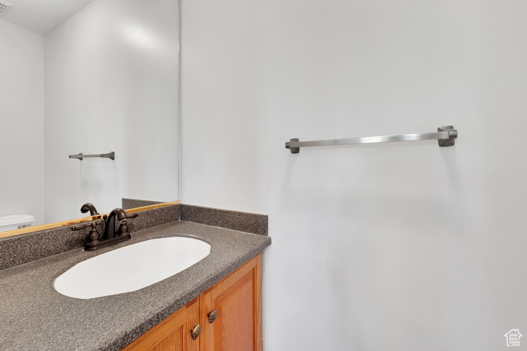 Bathroom featuring vanity and toilet