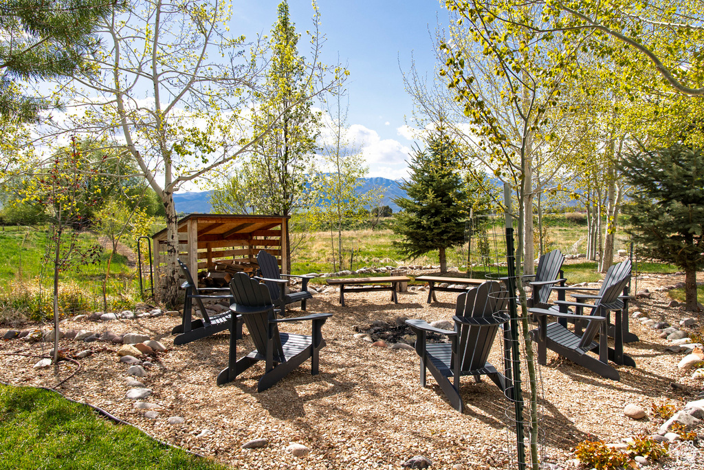 View of yard featuring a fire pit and a mountain view