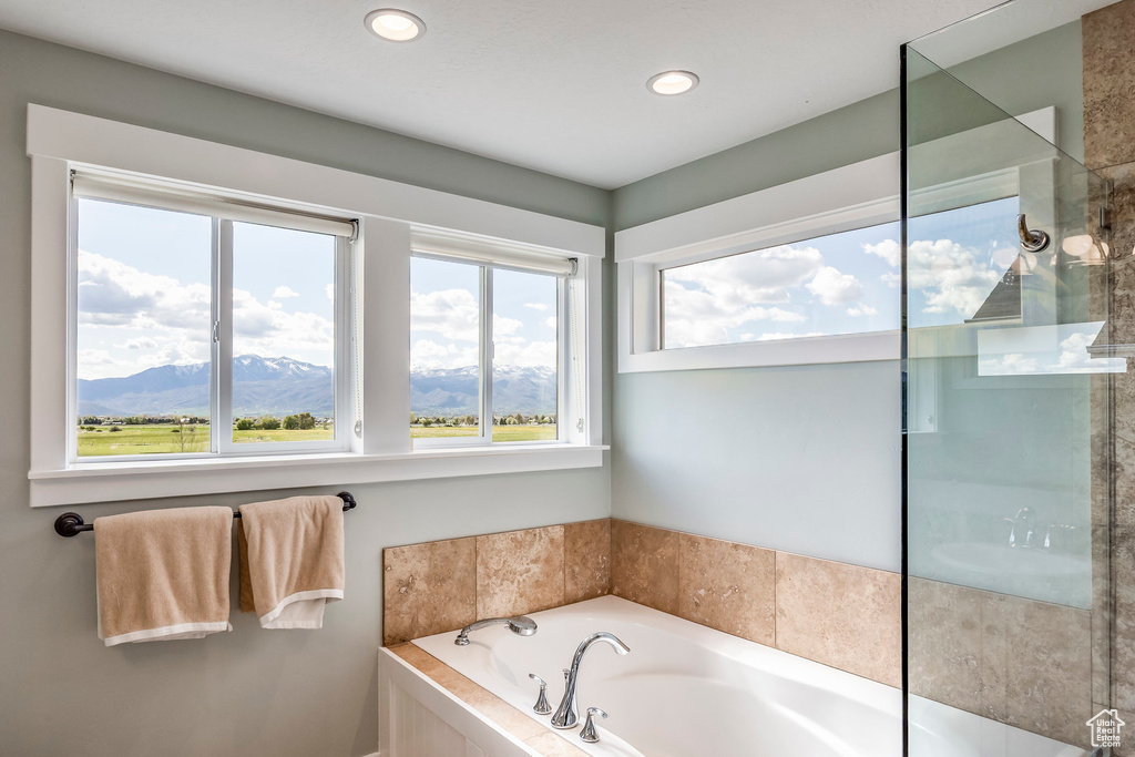 Full bath with a bath, a mountain view, recessed lighting, and a shower