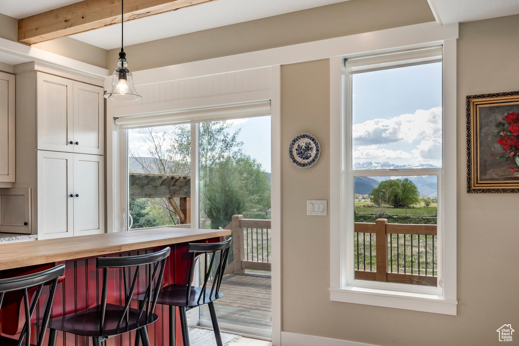 Doorway to outside with beam ceiling