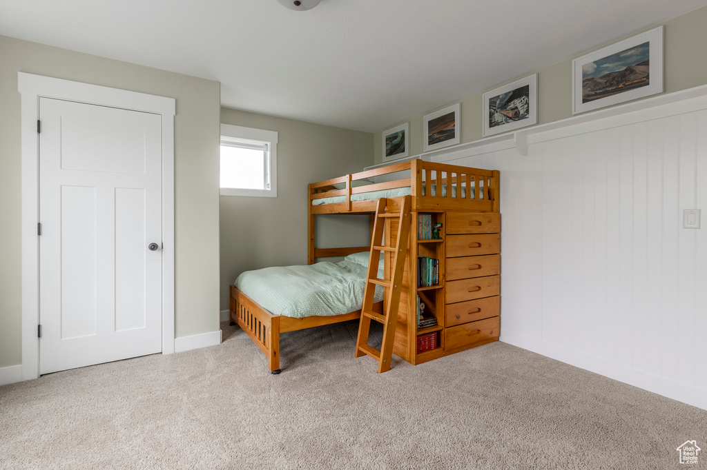Bedroom featuring carpet flooring and baseboards