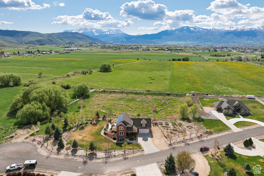 View of rural area featuring a mountain backdrop and a pastoral area
