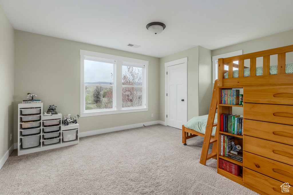 Sitting room featuring carpet floors and baseboards