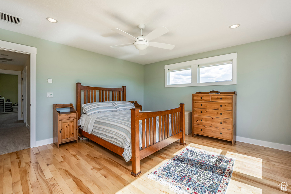Bedroom with light wood finished floors, recessed lighting, baseboards, and ceiling fan