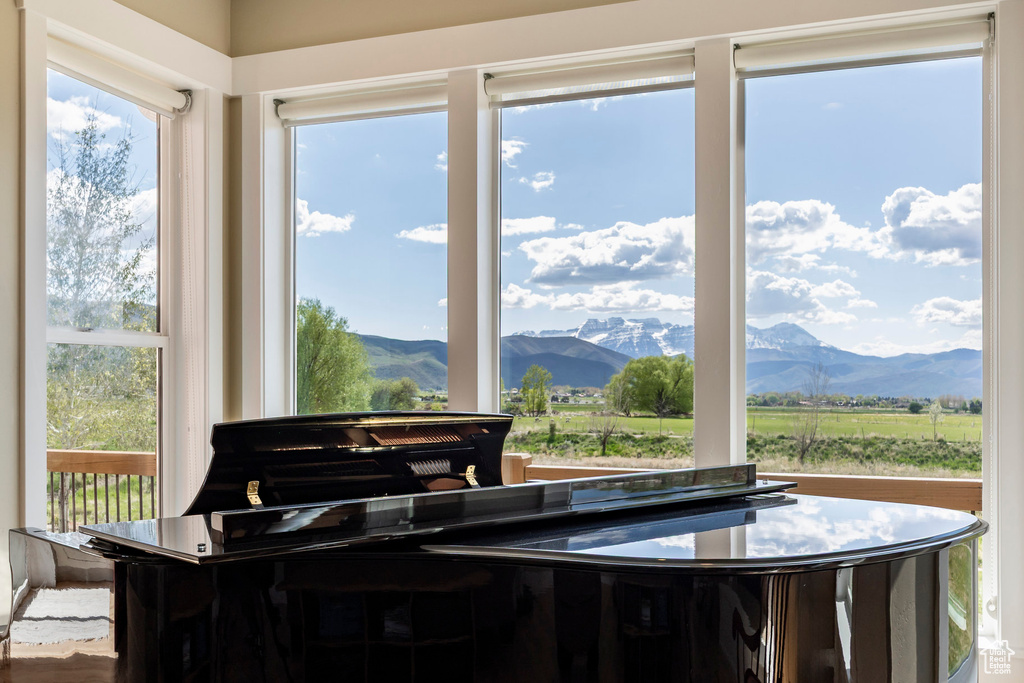 Sunroom featuring a mountain view and plenty of natural light