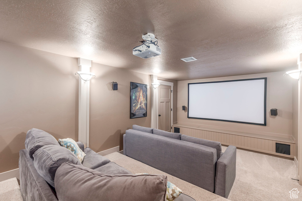 Cinema room with baseboards, carpet flooring, and a textured ceiling