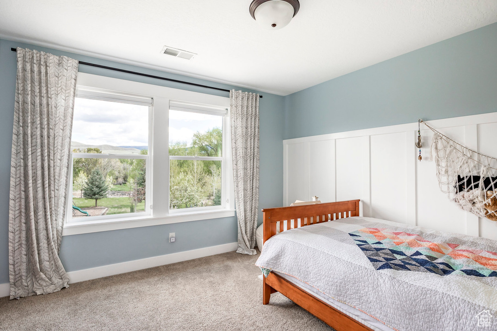 Carpeted bedroom featuring baseboards