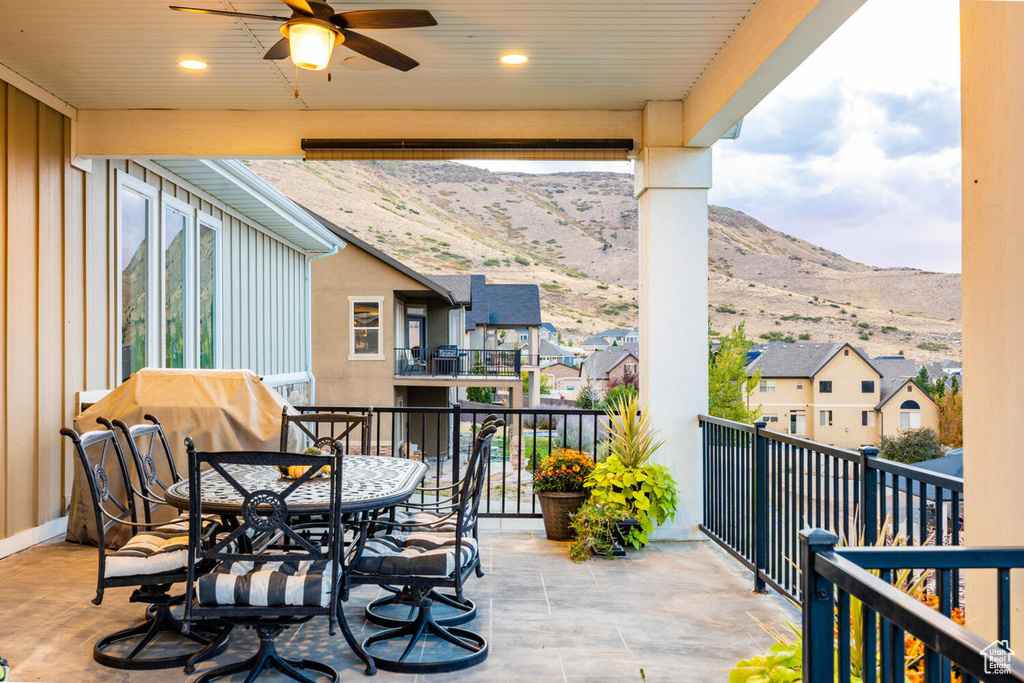 Balcony with a ceiling fan, a mountain view, a residential view, and outdoor dining space