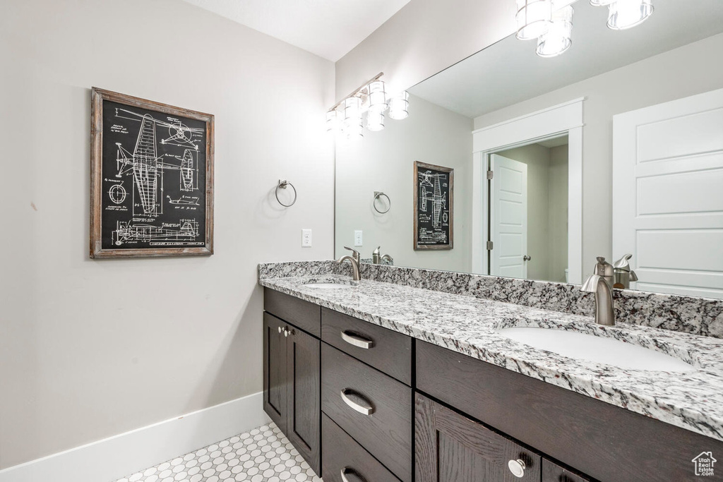 Bathroom featuring double vanity and baseboards