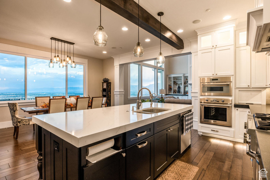 Kitchen featuring a sink, dark wood-style floors, white cabinetry, recessed lighting, and dark cabinetry