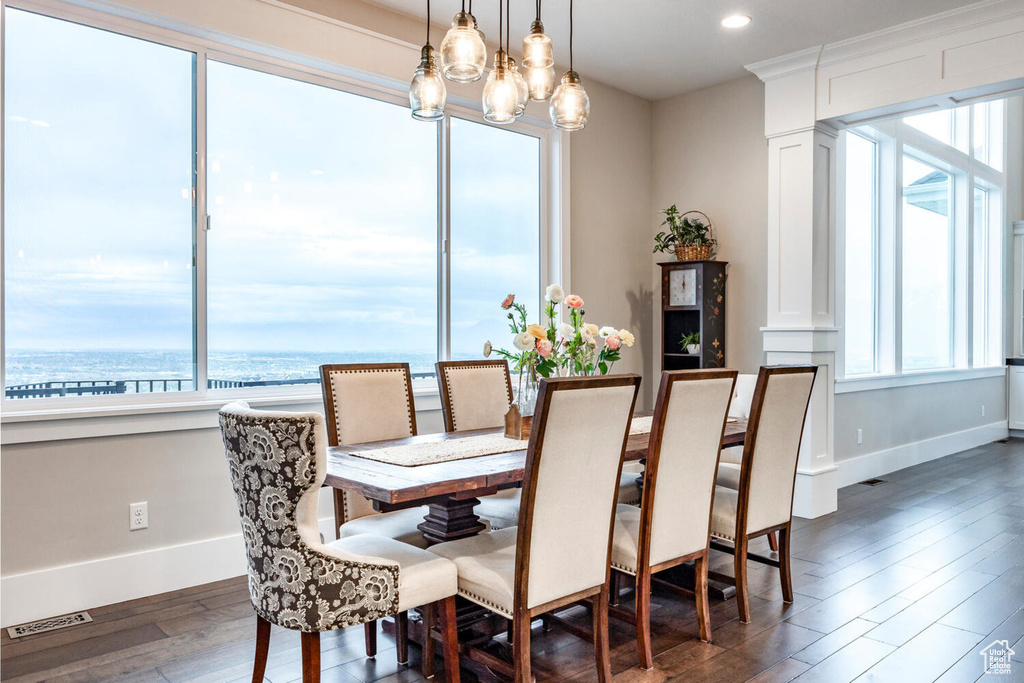 Dining area with healthy amount of natural light, baseboards, dark wood-style flooring, and recessed lighting