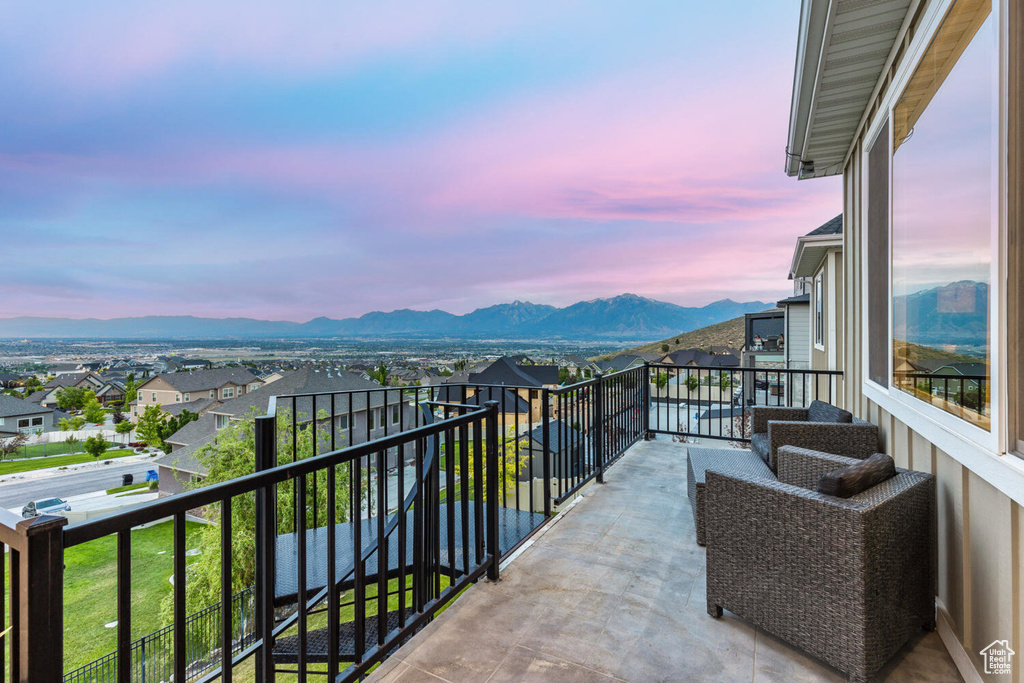 Balcony at dusk with a mountain view and a residential view