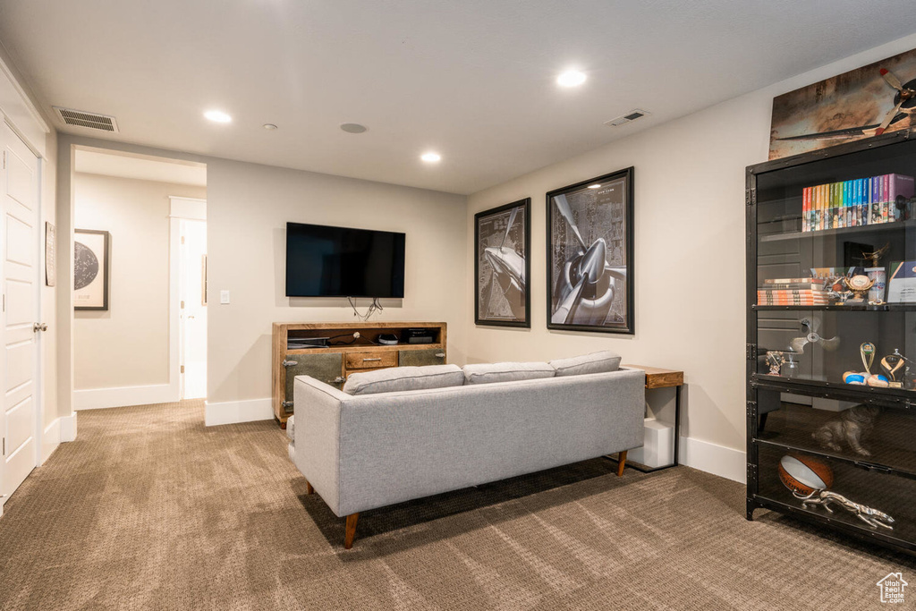 Living area featuring carpet flooring, recessed lighting, and baseboards