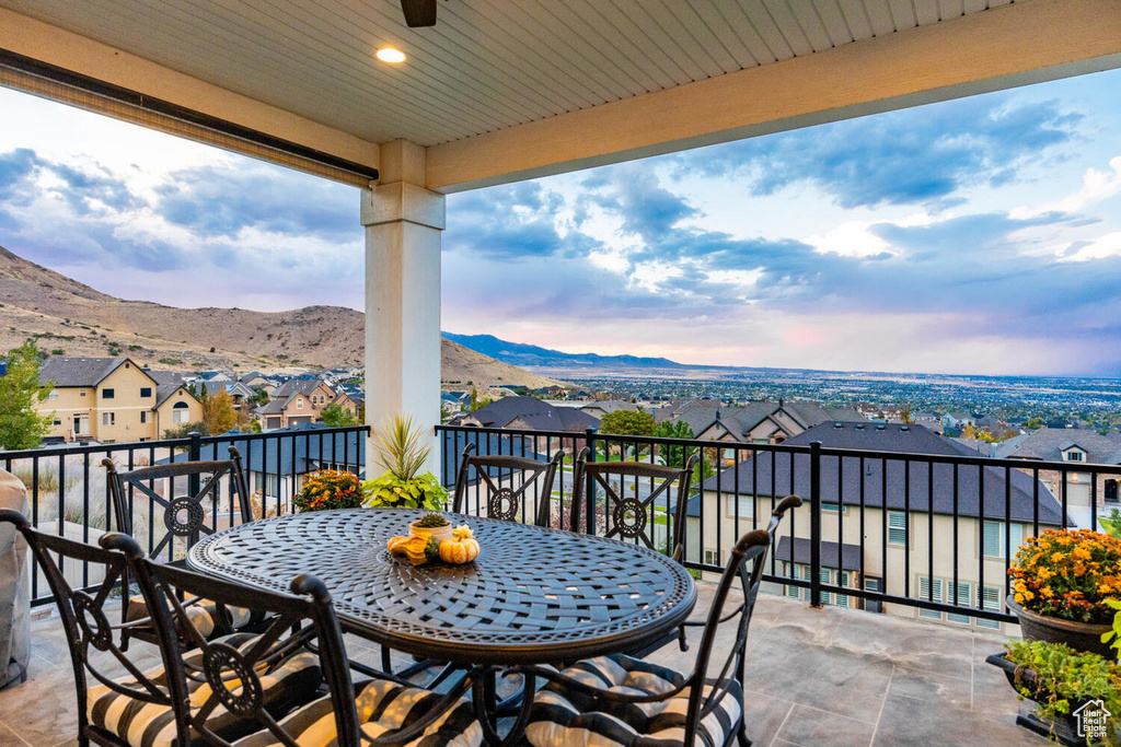 Balcony with a residential view, a mountain view, and outdoor dining area