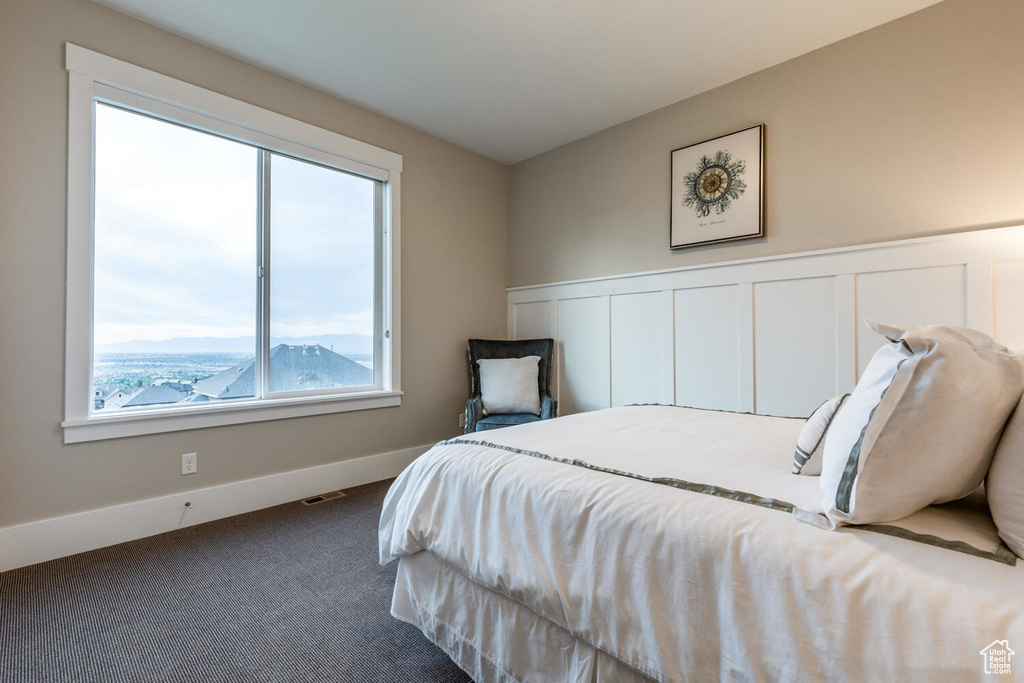 Carpeted bedroom featuring baseboards