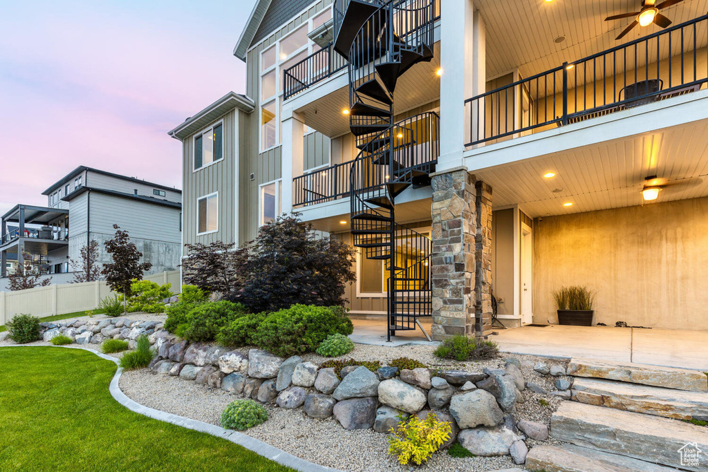 Property at dusk with stairs and fence