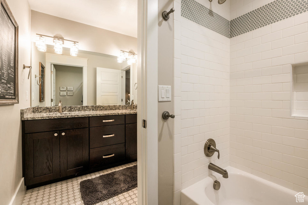 Full bathroom featuring bathing tub / shower combination, vanity, and baseboards