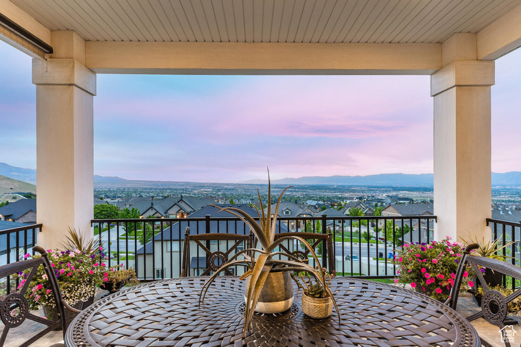 Balcony at dusk featuring a mountain view