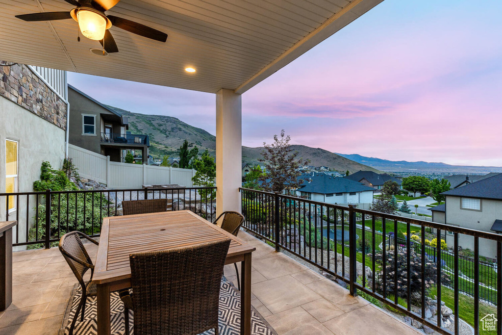 Balcony featuring a mountain view and ceiling fan