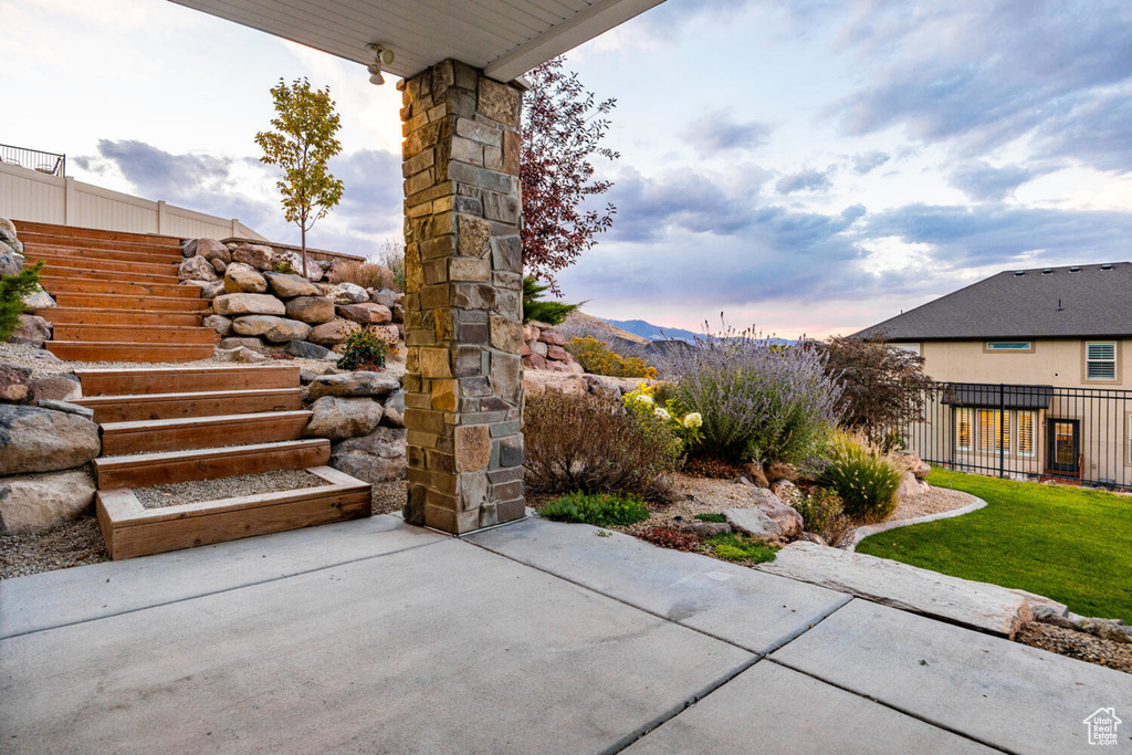 View of patio featuring fence