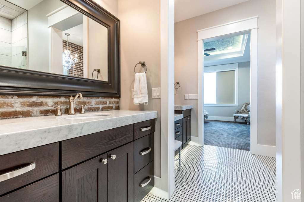 Full bath with vanity and baseboards
