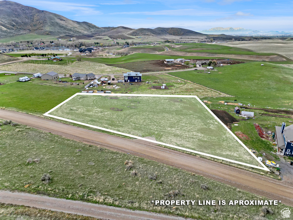 Aerial overview of property's location with property parcel outlined and a mountainous background