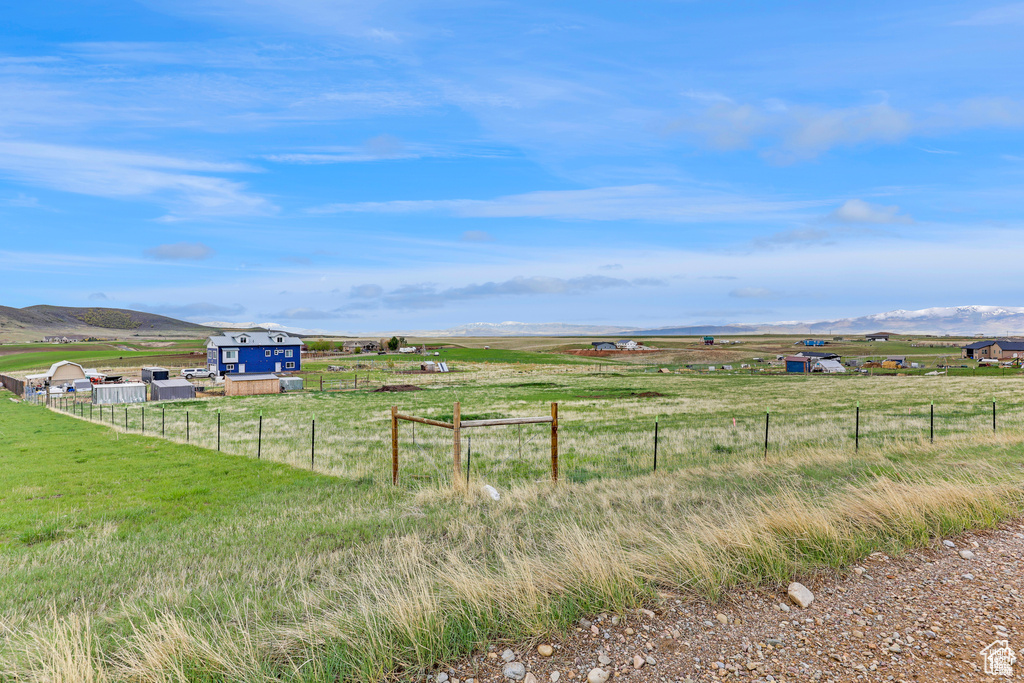 View of yard featuring a rural view and fence
