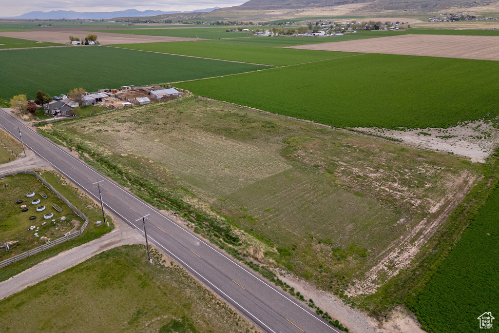 Aerial view of property and surrounding area featuring rural landscape and mountains