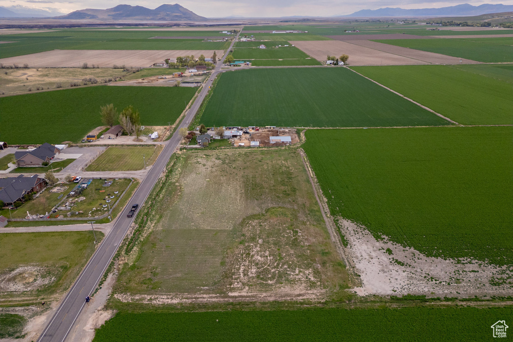 Aerial view of property's location featuring rural landscape, abundant farmland, and a mountain backdrop
