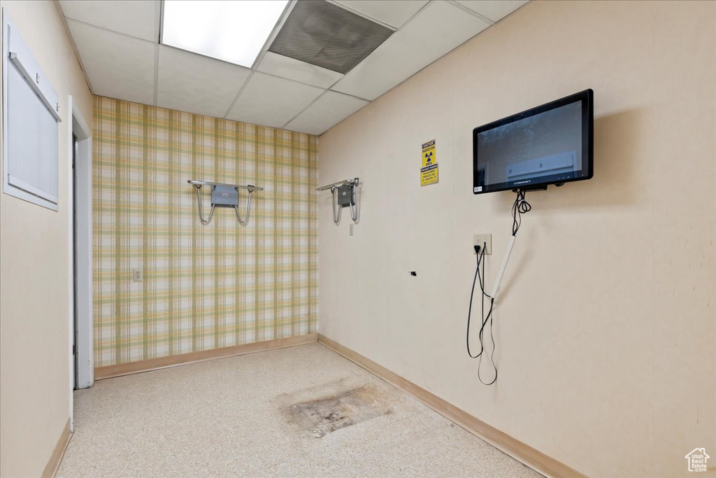 Interior space featuring baseboards, wallpapered walls, and carpet floors