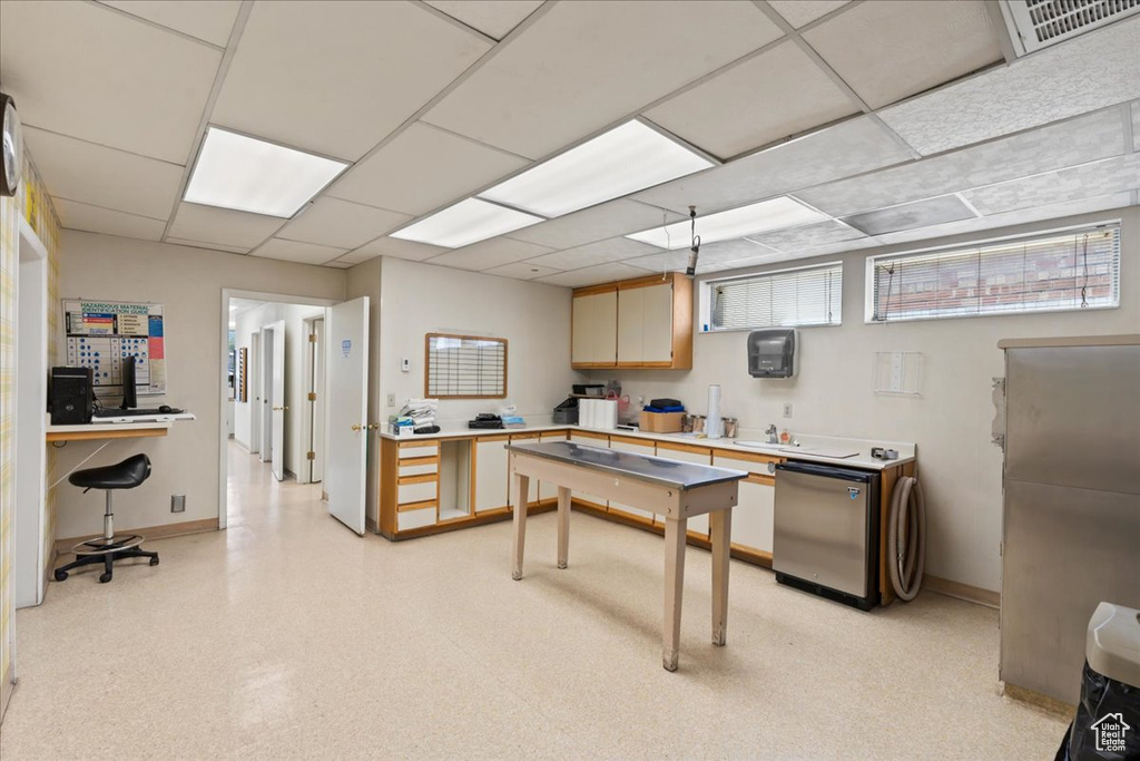 Office space featuring baseboards and a paneled ceiling