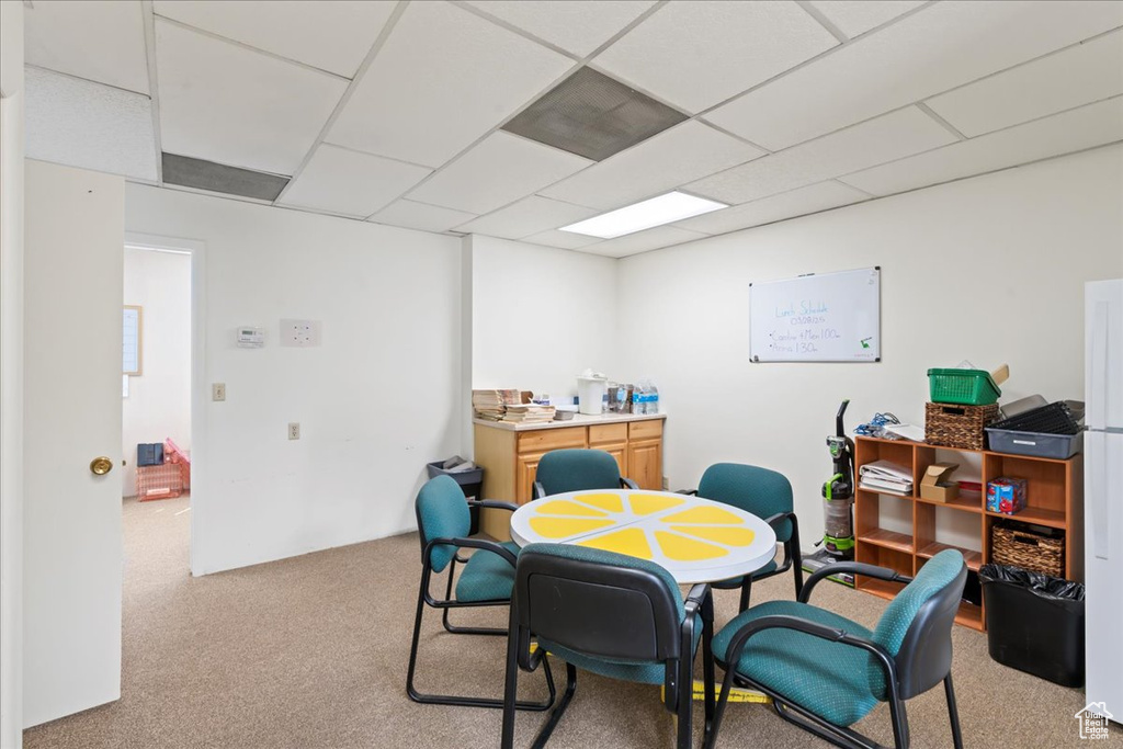 Office area with carpet flooring and a drop ceiling