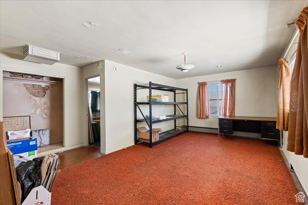 Unfurnished bedroom with a baseboard radiator and baseboards
