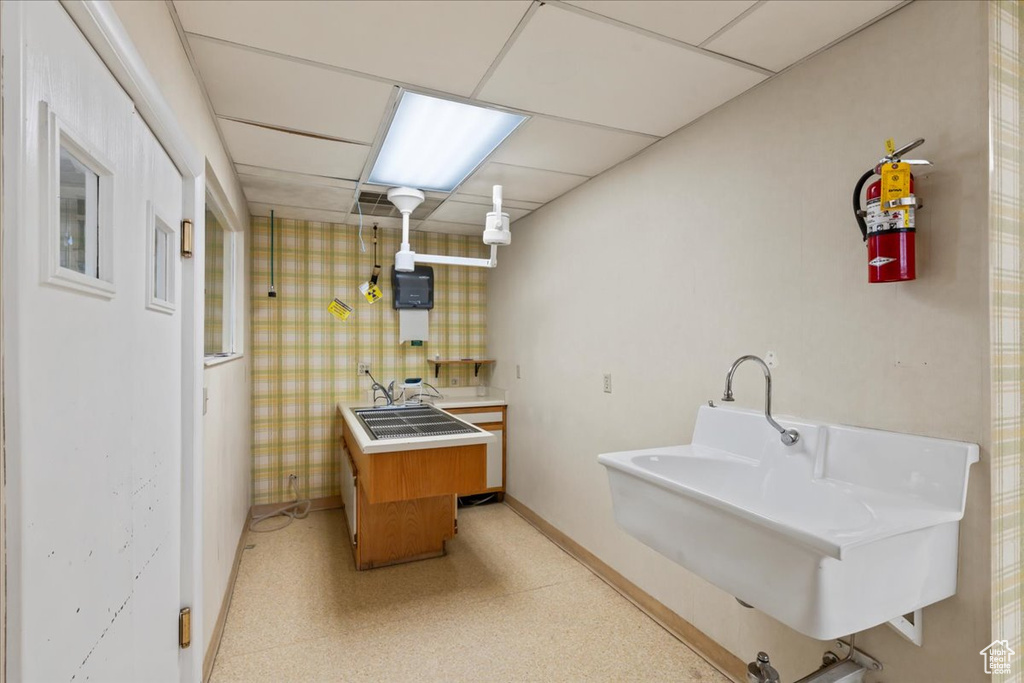 Laundry area featuring baseboards and a sink