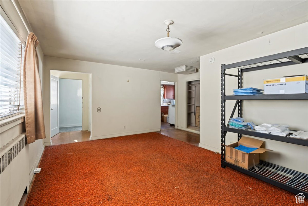 Bedroom with radiator heating unit and baseboards